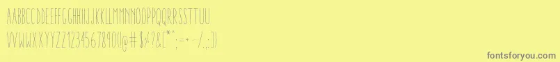AracneUltraCondensedLight-Schriftart – Graue Schriften auf gelbem Hintergrund