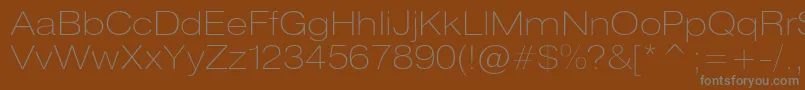 Heliosextthinc-fontti – harmaat kirjasimet ruskealla taustalla