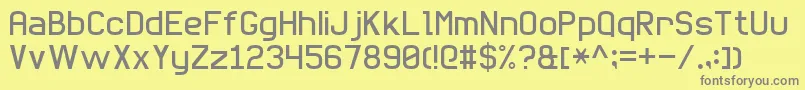 BasicSansSerif7-fontti – harmaat kirjasimet keltaisella taustalla