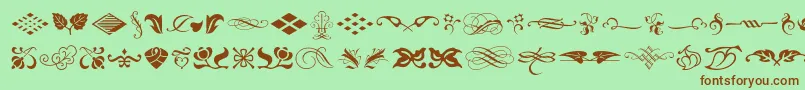 フォントTypeembellishmentsone – 緑の背景に茶色のフォント