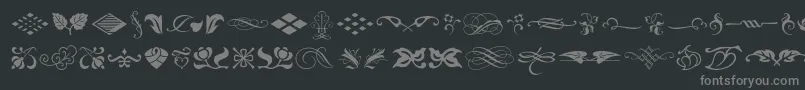 フォントTypeembellishmentsone – 黒い背景に灰色の文字