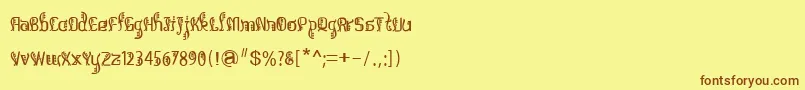 フォントBitlingsulochicalligraReg – 茶色の文字が黄色の背景にあります。