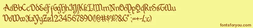 フォントQuillswordrotate – 茶色の文字が黄色の背景にあります。