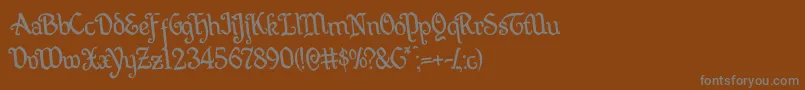 フォントQuillswordrotate – 茶色の背景に灰色の文字