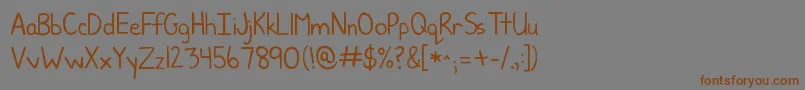 フォントKgjunebug – 茶色の文字が灰色の背景にあります。