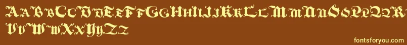 Blackinitialtext-fontti – keltaiset fontit ruskealla taustalla