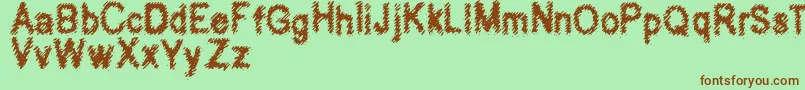 Hubbly-Schriftart – Braune Schriften auf grünem Hintergrund