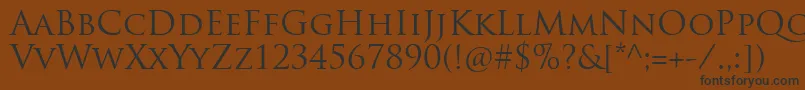 フォントTrajanproRegular – 黒い文字が茶色の背景にあります
