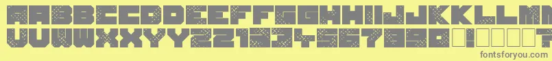 SevenOfOne-fontti – harmaat kirjasimet keltaisella taustalla