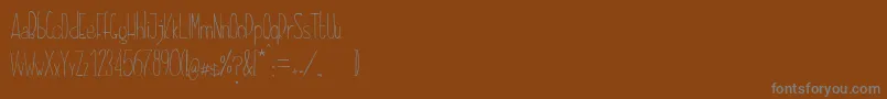 Czcionka DayonaElegant – szare czcionki na brązowym tle