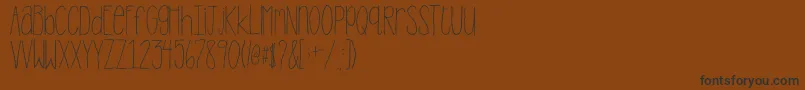 2peasStandTall Font – Black Fonts on Brown Background