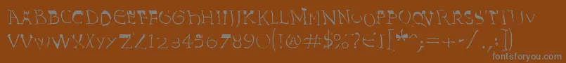 Czcionka InvasionLtHarold – szare czcionki na brązowym tle