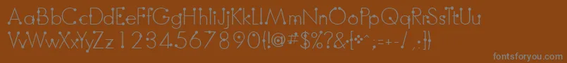 BoumboumFreeVersion-fontti – harmaat kirjasimet ruskealla taustalla