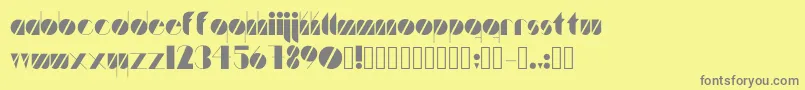 Artistica-fontti – harmaat kirjasimet keltaisella taustalla