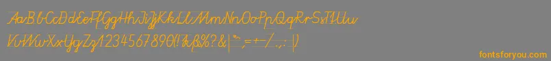 フォントGruenewaldVa1k – オレンジの文字は灰色の背景にあります。