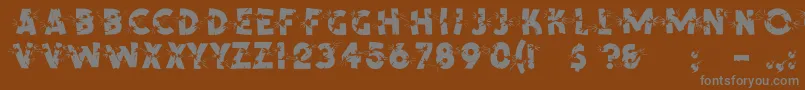 ShrapnelRegular-fontti – harmaat kirjasimet ruskealla taustalla