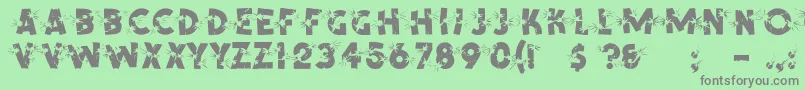ShrapnelRegular-fontti – harmaat kirjasimet vihreällä taustalla