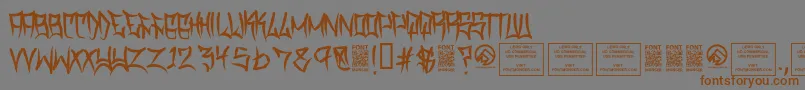 フォントTraviscountyRegular – 茶色の文字が灰色の背景にあります。