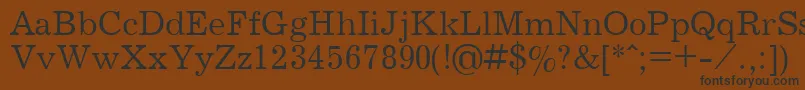 フォントJournpla – 黒い文字が茶色の背景にあります