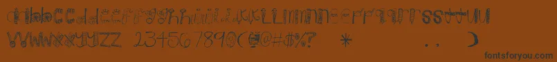 フォントCandy – 黒い文字が茶色の背景にあります