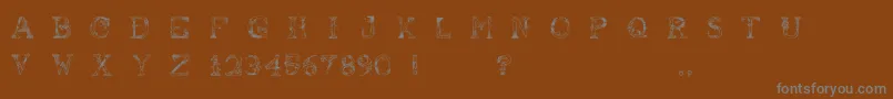 AbusivePencil-fontti – harmaat kirjasimet ruskealla taustalla