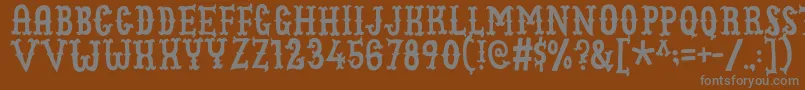 Cowboyjunkdemo-Schriftart – Graue Schriften auf braunem Hintergrund