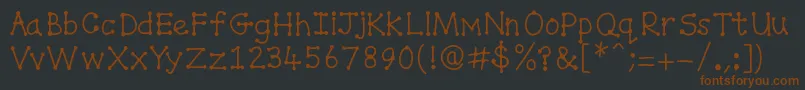 Spottydottie Font – Brown Fonts on Black Background