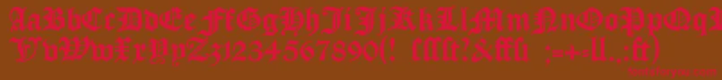 フォントManuskriptgotisch – 赤い文字が茶色の背景にあります。