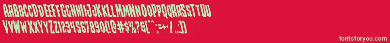 Creepycrawlersleft-Schriftart – Grüne Schriften auf rotem Hintergrund