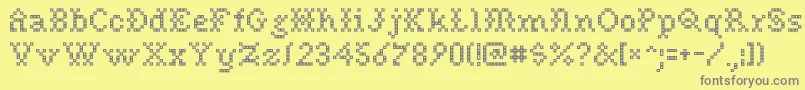 Needlepoint-Schriftart – Graue Schriften auf gelbem Hintergrund