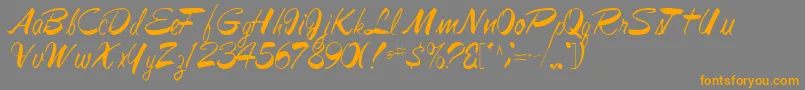 フォントJesabellfont72Regular – オレンジの文字は灰色の背景にあります。