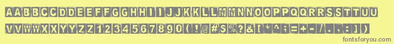 StampedDsg-Schriftart – Graue Schriften auf gelbem Hintergrund