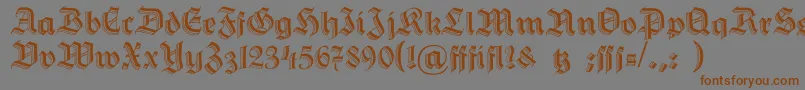 フォントHermannGotisch – 茶色の文字が灰色の背景にあります。