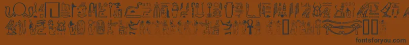 フォントGwglyptt – 黒い文字が茶色の背景にあります