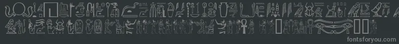 フォントGwglyptt – 黒い背景に灰色の文字