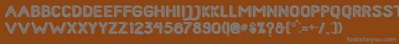 HometownRoughBoldShadow-fontti – harmaat kirjasimet ruskealla taustalla
