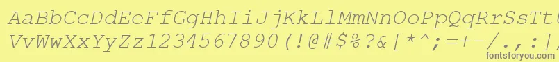 CourierPsItalic-fontti – harmaat kirjasimet keltaisella taustalla