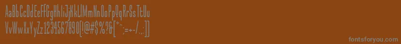 Czcionka MalstockItcTt – szare czcionki na brązowym tle