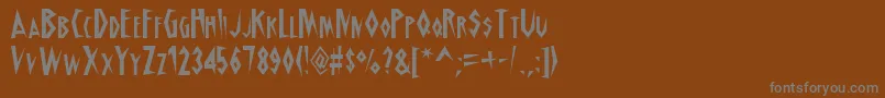 フォントSchrillAoe – 茶色の背景に灰色の文字