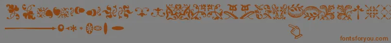 フォントSabonnextLtOrnaments – 茶色の文字が灰色の背景にあります。