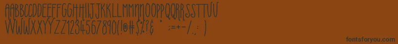 Uberfriends Font – Black Fonts on Brown Background