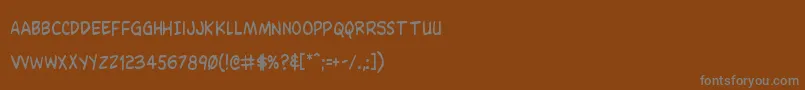 フォントDominomaskcond – 茶色の背景に灰色の文字