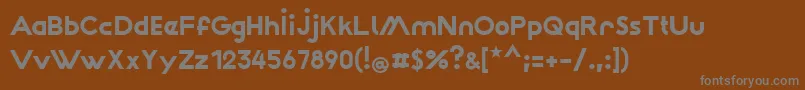 Wattauchimma-fontti – harmaat kirjasimet ruskealla taustalla