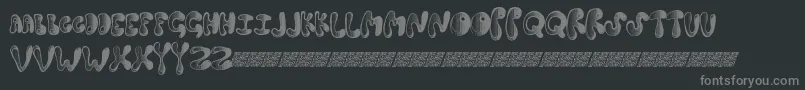 Springdance-fontti – harmaat kirjasimet mustalla taustalla