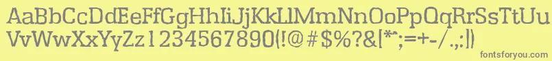EnschedeantiqueRegular-fontti – harmaat kirjasimet keltaisella taustalla