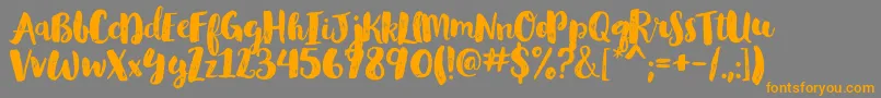 GlamourbrushRegular-Schriftart – Orangefarbene Schriften auf grauem Hintergrund