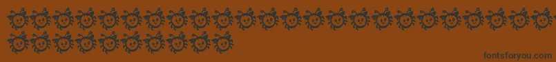 Шрифт CuddlebugsBug – чёрные шрифты на коричневом фоне