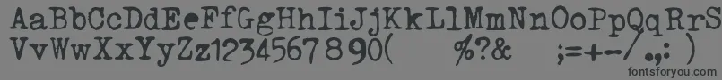 TriumphTippa-Schriftart – Schwarze Schriften auf grauem Hintergrund