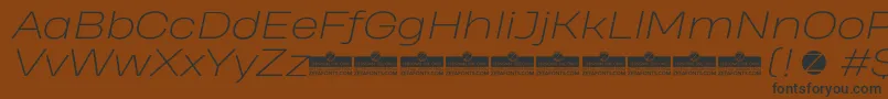 Шрифт HeadingProWideExtralightItalicTrial – чёрные шрифты на коричневом фоне
