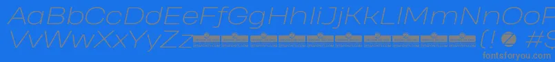 Fonte HeadingProWideExtralightItalicTrial – fontes cinzas em um fundo azul